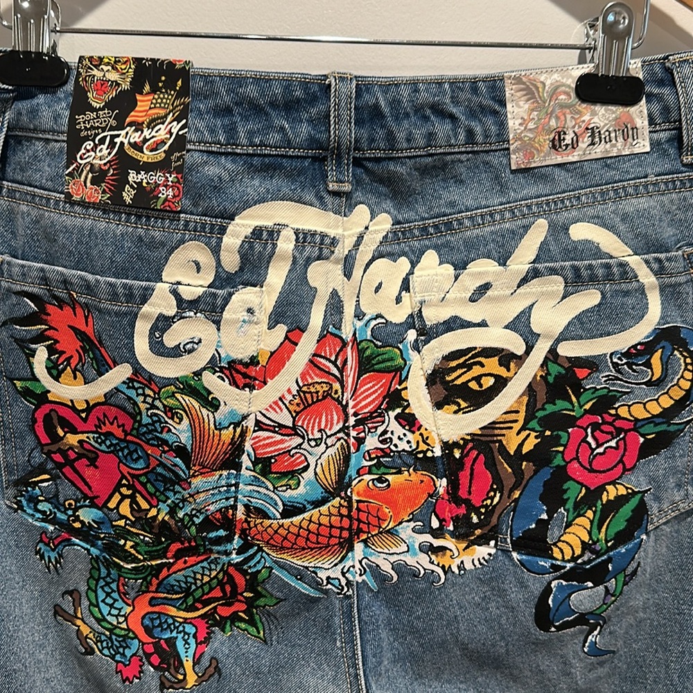 NWT Ed Hardy Baggy Born Free Blue Jeans with Designs on the back.